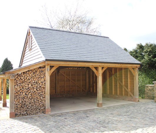 Radnor Oak's two bay oak garage with log store to one end.